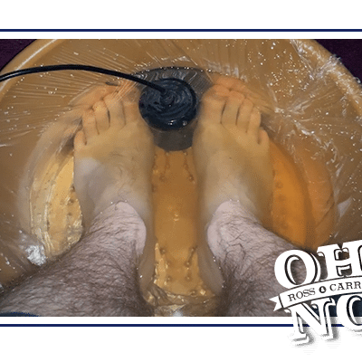 Ross' feet in a bucket of orange-brown water