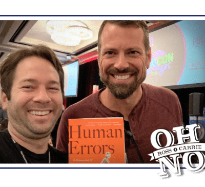 Ross and Nathan Lents standing together holding a copy of Human Errors