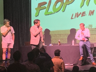 Stuart, Dan and Elliott on stage holding microphones