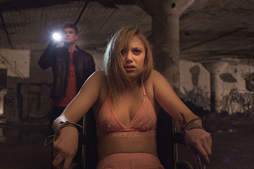 Maika Monroe from 'It Follows' strapped to a wheelchair