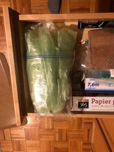 Many plastic bags contained in a ziploc bag inside a kitchen drawer
