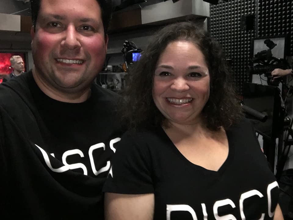 Dan and Lana wearing matching shirts that say DISCO