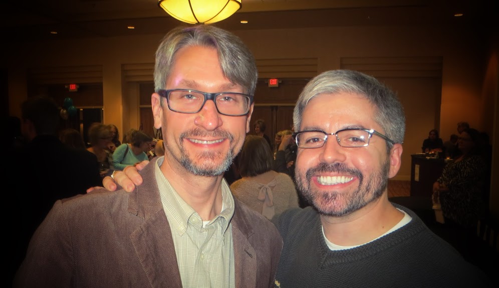 two men wearing glasses together