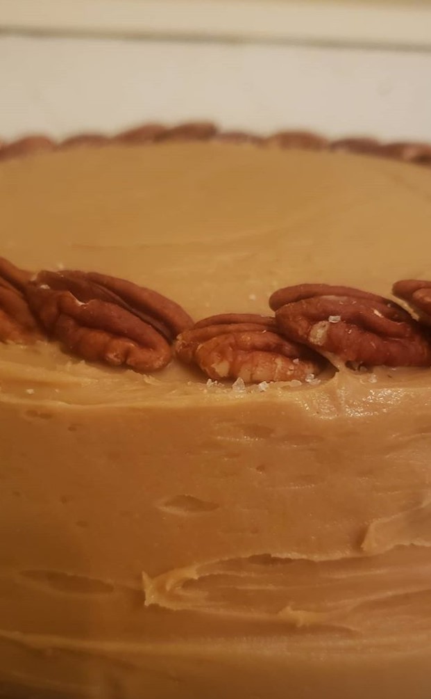 cake with icing and pecans around perimeter