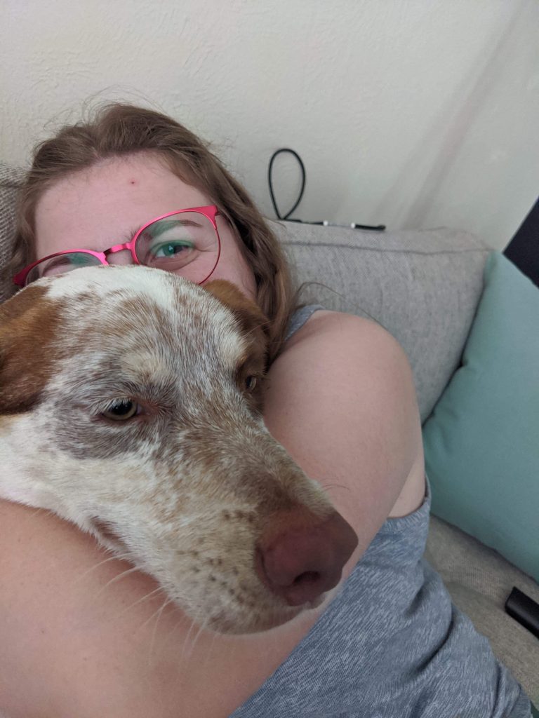 a woman cuddling a dog