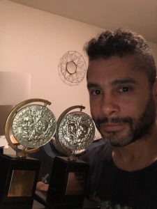 Wilson Jermaine Heredia in front of his two Tony awards