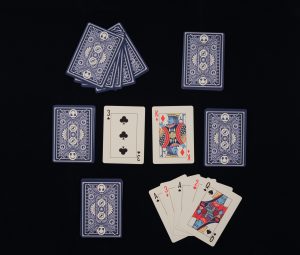Maximum Fun playing cards arranged in the layout described in the rules for Speed