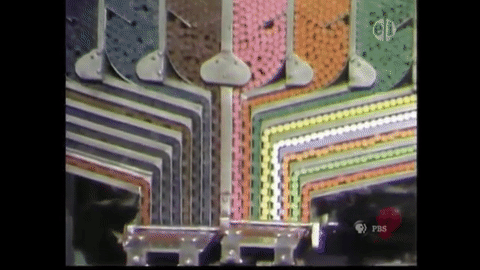 A factory machine sorting and packing crayons