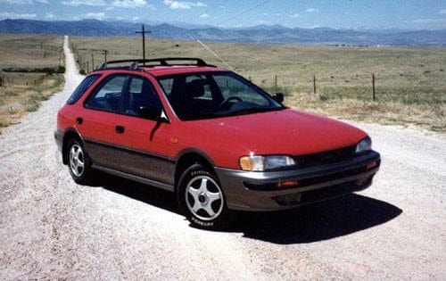 A front and side angle of a red Subaru Impreza