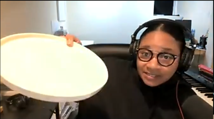Guest Bailiff Jean Grae, photographed during the Zoom recording, holding a white deep plate