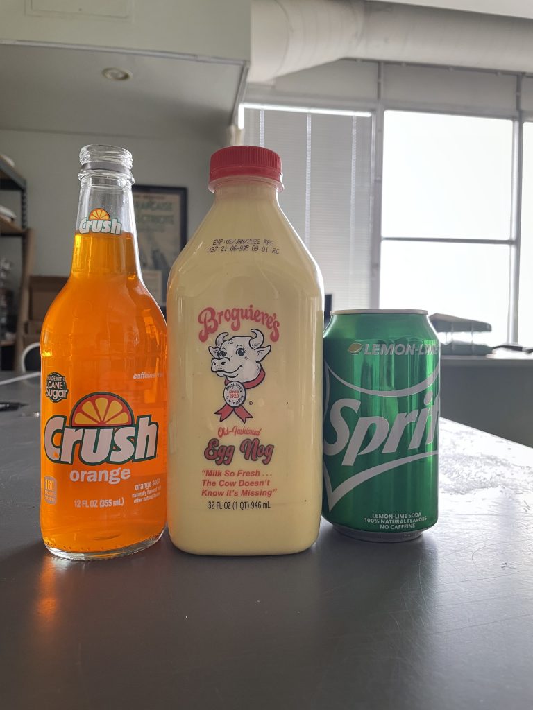 From left to right: glass bottle of Orange Crush, Broguiere's egg nog, can of Sprite