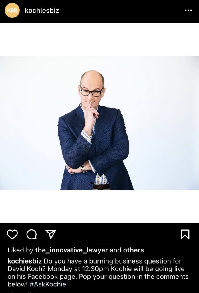 A screenshot from an instagram account, @kochiesbiz. It shows a white, bald man in front of a white backdrop, wearing a suit and glasses, with a finger up to his mouth as if he's being pitched an idea and he is considering it.