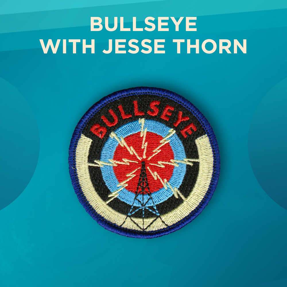 Bullseye with Jesse Thorn. A background of dark blue, white, black, light blue and red circles, with the word BULLSEYE in red. In the foreground, a radio tower radiates electric bolts.