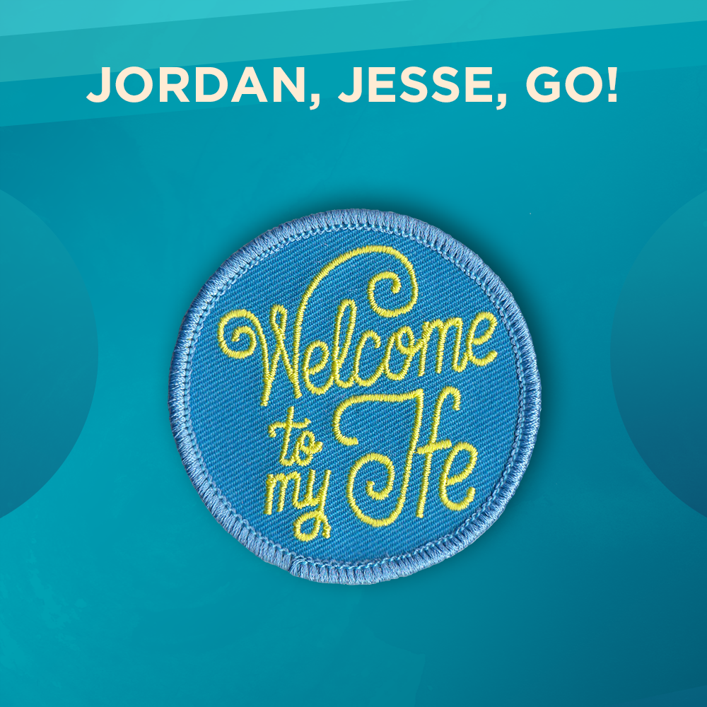 Jordan, Jesse, Go! A round pin with a sky-blue background and the words “Welcome to my Ife” written in curly lettering.