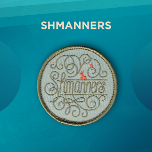 Shmanners. Shmanners is written in loopy lettering, with loopy embellishments surrounding the letters. There is also a small deer and dove. The lettering is a light olive green, the background is a soft mint green, and the deer and dove are dark orange.