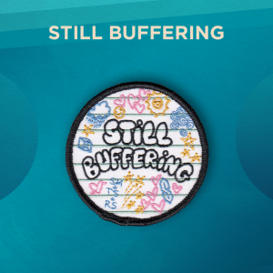 Still Buffering. Still Buffering is outlined in black in bubbly lettering with colorful doodles of hearts, suns, stars, the “cool S” and more. The background is lined like notebook paper.