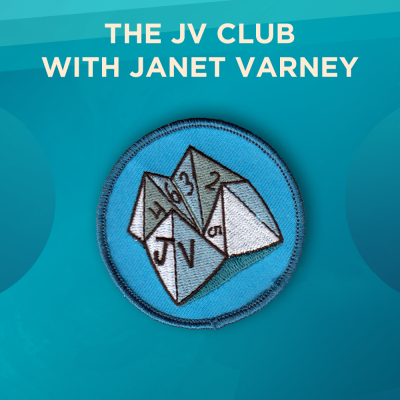 The JV Club with Janet Varney. A paper fortune teller with the letters JV on the front on a blue background.