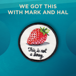 We Got This with Mark and Hal. A strawberry on a white background. The patch says “This is not a berry”. There is a black border around the round patch.
