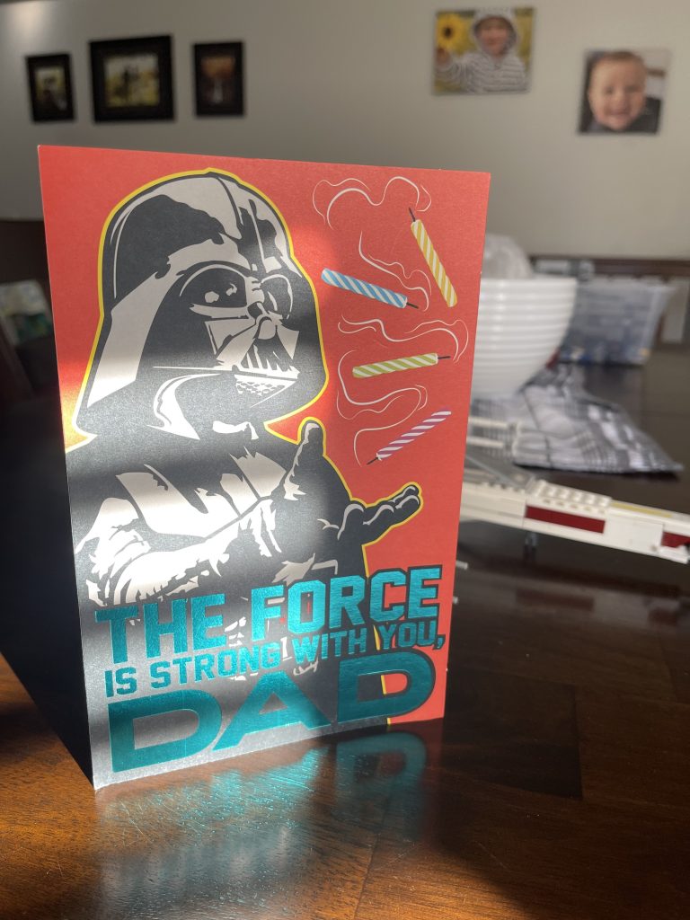 A birthday card with Darth Vader on it that says 