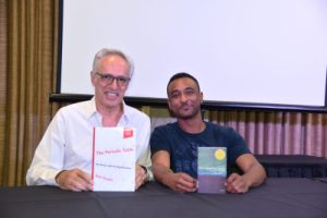 Dr. Eric Scerri and Brandon Blackwell. They're holding up two editions of the book "The Periodic Table" by Scerri