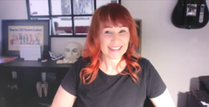 Susie Louis in a zoom window. She's wearing a black shirt and has red hair