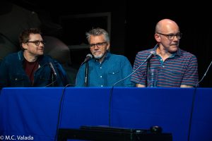 Jed Whedon and Jeffrey Bell on stage at the table with Rob Corddry