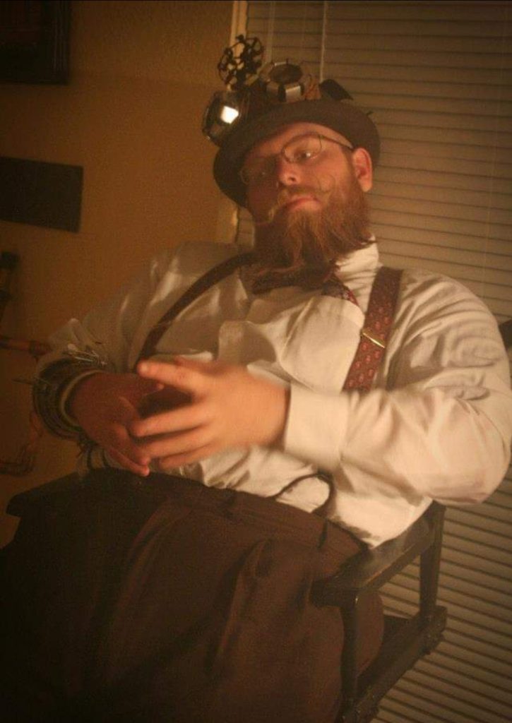 A photo of a man in a steampunk looking outfit