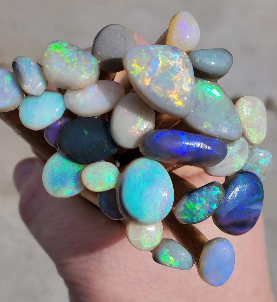 A hand holding shiny rocks