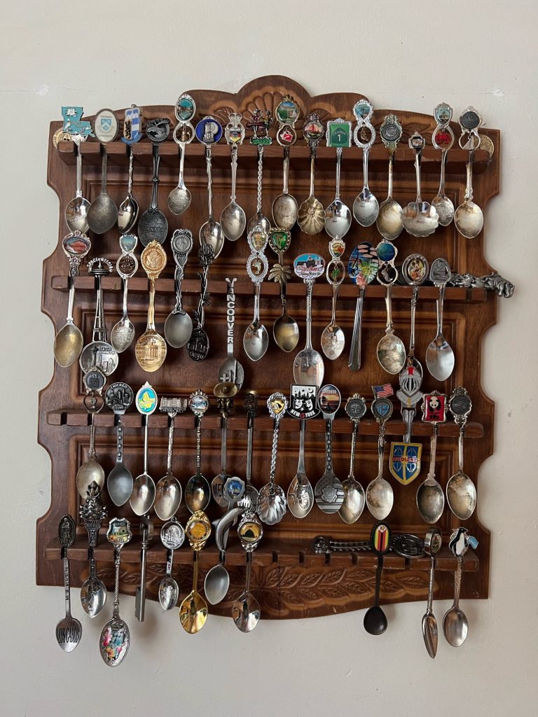 A full souvenir spoon collection rack