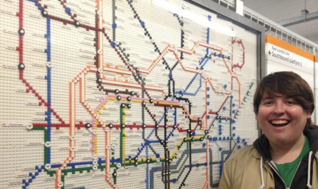 A man standing in front of a lego tube map