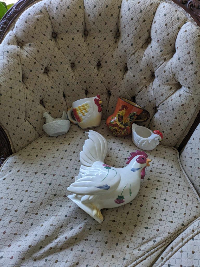 ceramic chicken mugs and other decor items on a chair