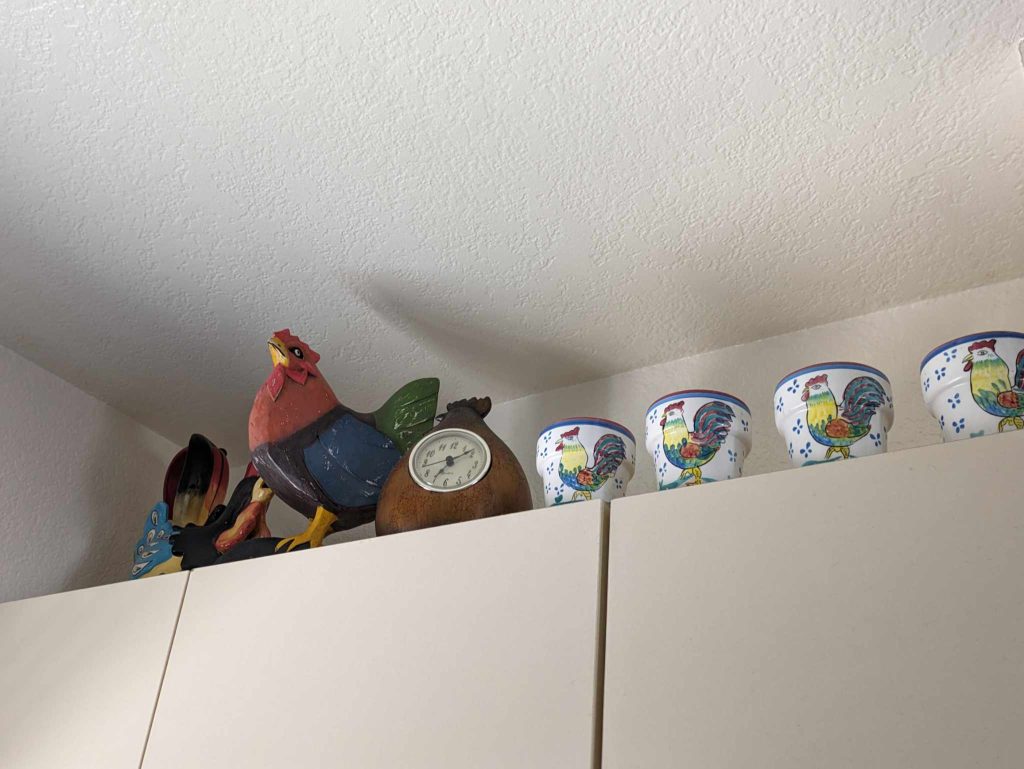 more chicken decor items on top of a cabinet