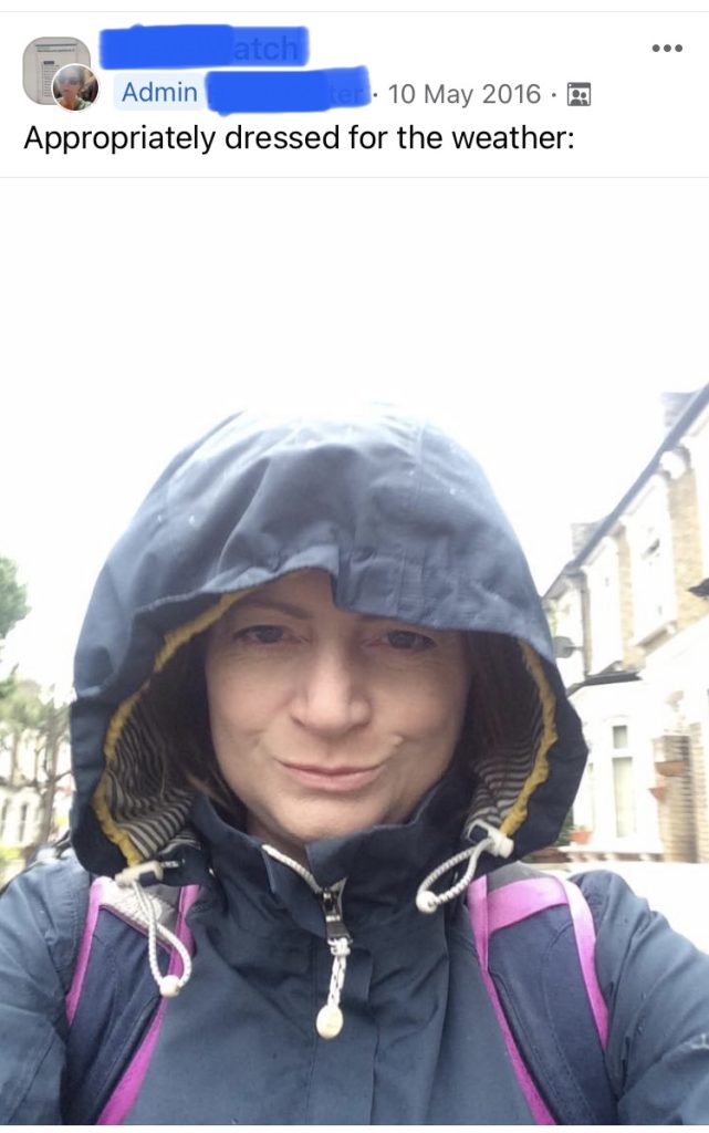 a selfie of a woman in the rain wearing a hood