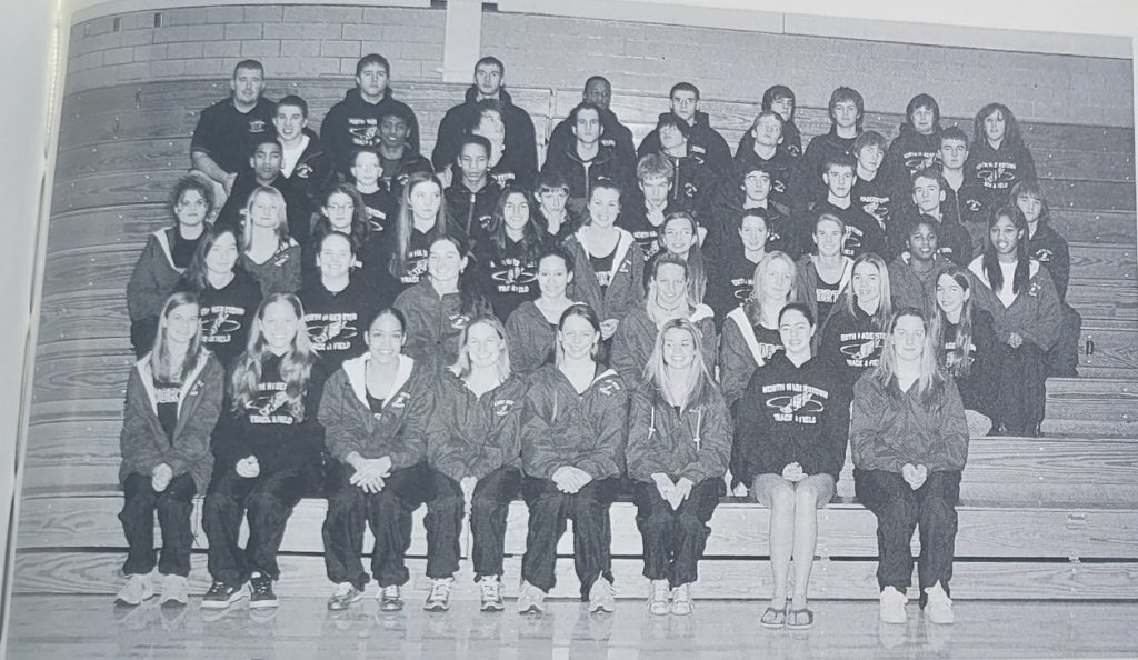 A black and white yearbook photo of a track team