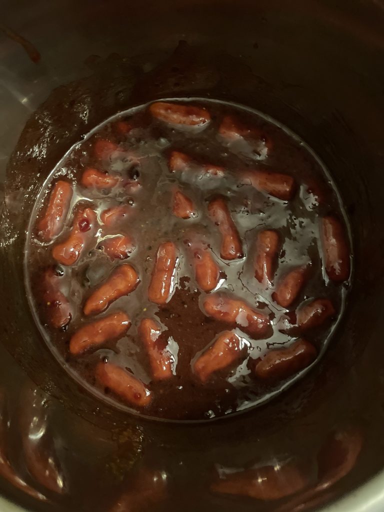 cocktail weenies in a slow cooker with a dark brown sauce