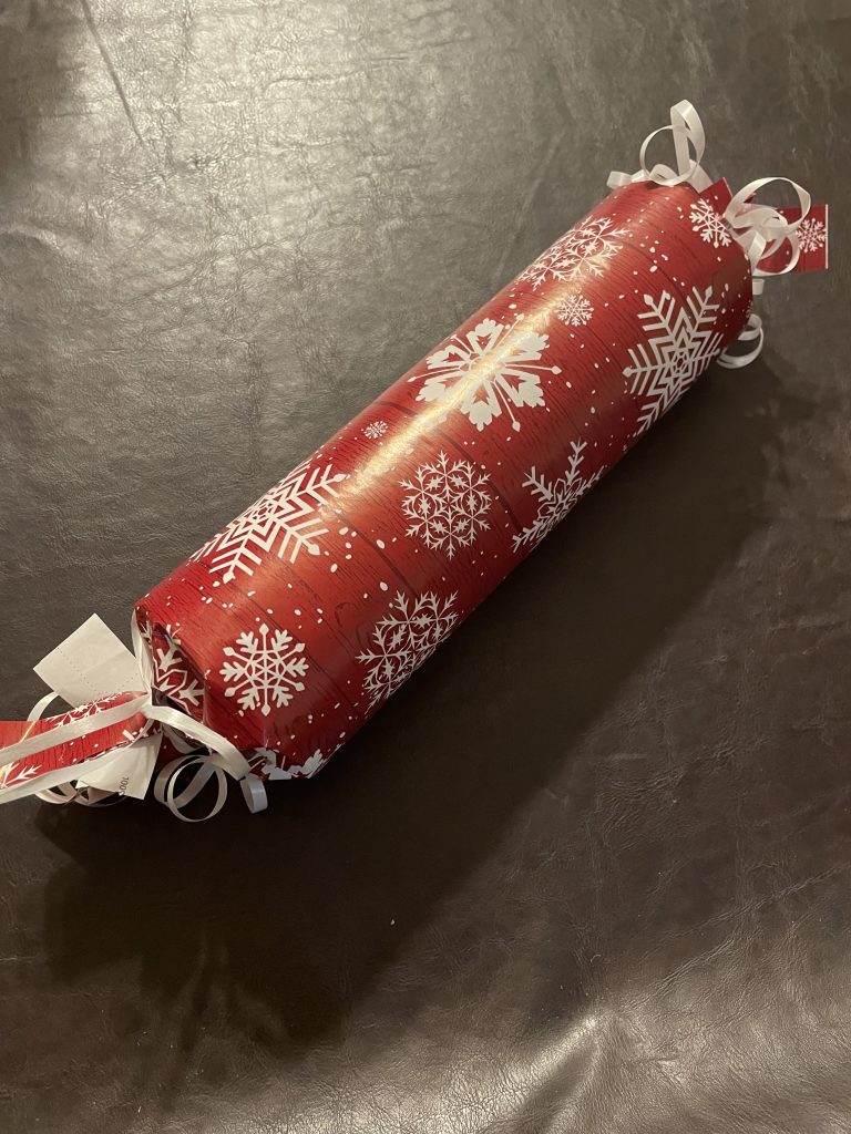 A cylindrical-shaped Christmas present