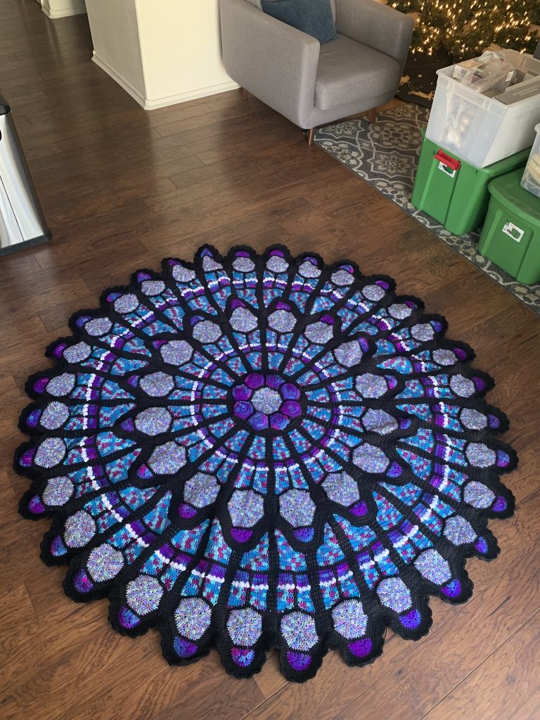 A circle-shaped large crocheted blanket