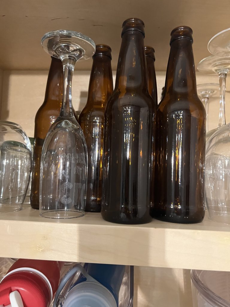 empty beer brewing bottles on a shelf