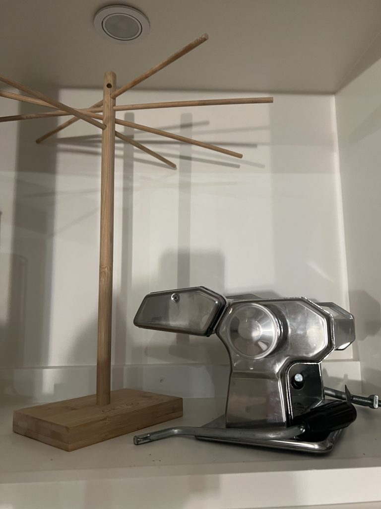 pasta drying rack and pasta maker on a shelf