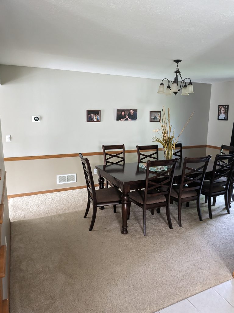 A large dining room wall with three 4 x 6 framed photos on it