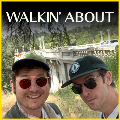 Allan McLeod and Dan Stevens look into the camera. In the background is a concrete bridge with traffic.