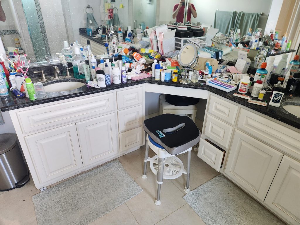 A bathroom counter completely covered in products on every square inch.