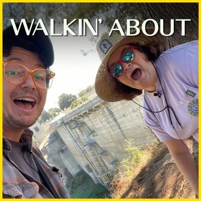 Allan McLeod and Betsy Sodaro smile at the camera. Devil's Gate Dam is behind them.