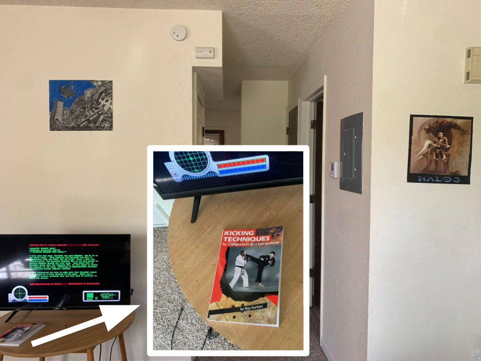 A room with a view down a hallway, and a monitor on a side table. Inset in the image is a closeup of a book on that sidetable