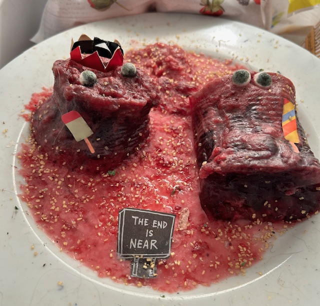 The same cranberry sauces, now having been frozen with edible glitter on the plate, fake popsicles and a sign that says 