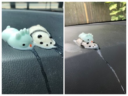 Squishy fidget toys on top of a car dashboard that have melted