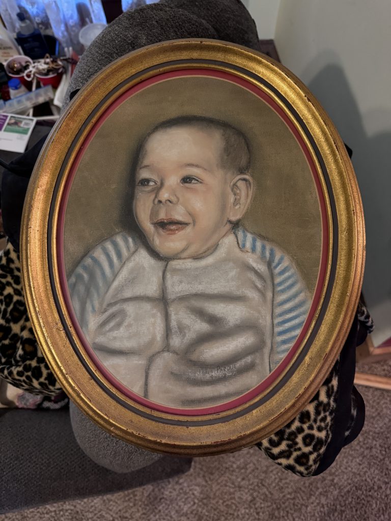 A painting in an oval frame of the baby photo previously posted