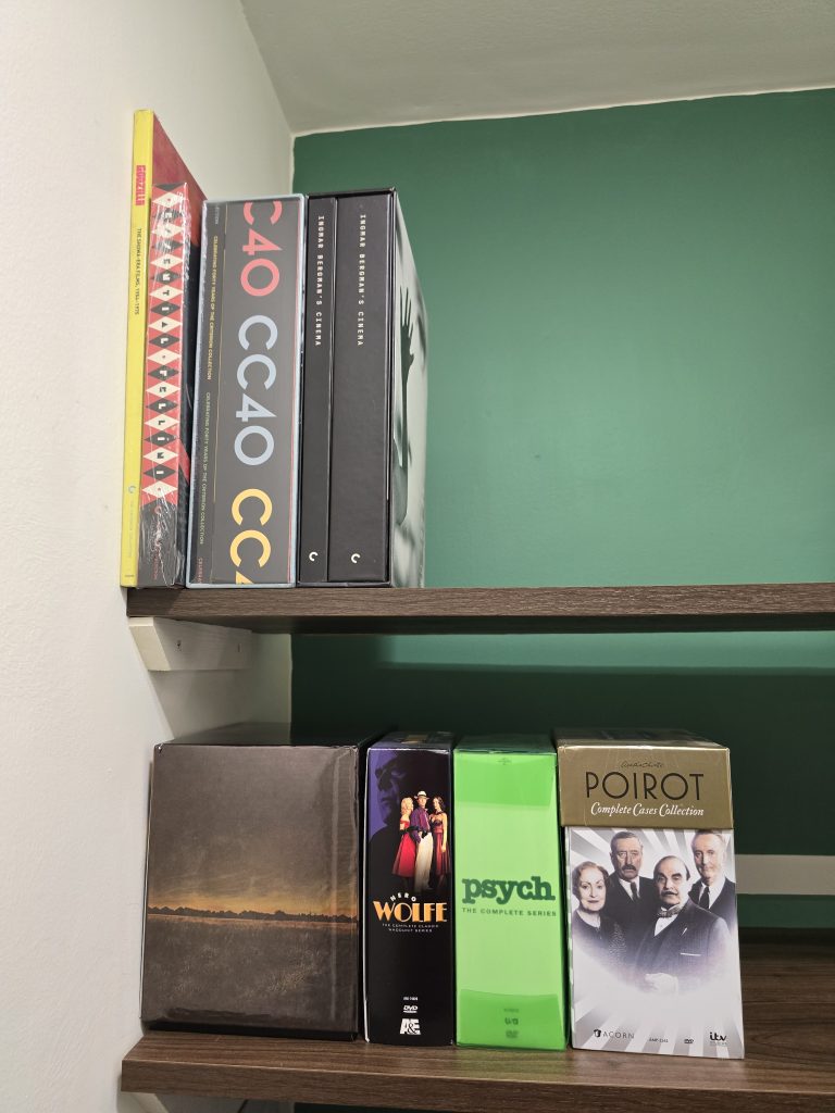 Two shelves with DVD/Blu-ray box sets including the Criterion Collection 40 box set, the complete PSYCH series, and POIROT