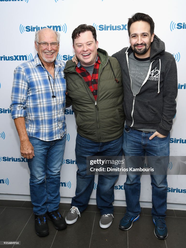Three men standing in front of a step and repeat
