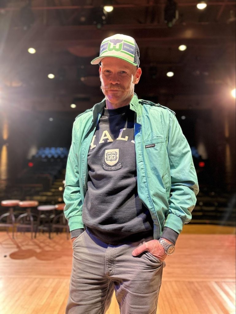 A man with a Hartford Whalers cap and Yale t-shirt